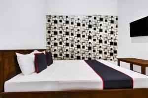 Ένα ή περισσότερα κρεβάτια σε δωμάτιο στο Hotel O Oteng Stay