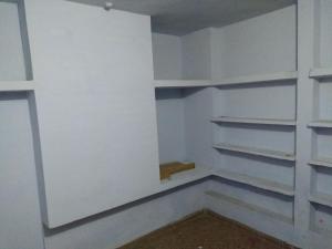 a walk in closet with white walls and shelves at Cozy Homestay in Prayagraj
