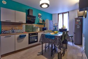 a kitchen with a table and chairs in a room at Le Clos de Léa Wifi Metz Centre Ville in Metz +16 photos