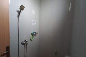 a shower stall in a bathroom with a shower head at OYO 94715 Homestay Kembar Syariah in Sragen +16 photos