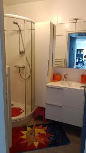 a bathroom with a shower and a sink and a toilet at Les sables d’or in Saint-Jean-de-Monts