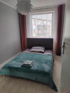Ένα ή περισσότερα κρεβάτια σε δωμάτιο στο Apartament nad Zalewem