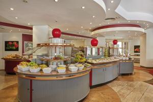 a buffet line with food on display in a restaurant at Sunday Hotel Bad Soden in Bad Soden am Taunus