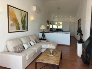 a living room with a couch and a coffee table at Riera Rossello 2 by SOM menorca in Fornells