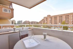 a table with wine glasses on a balcony at Magic Sunset View in El Borseral