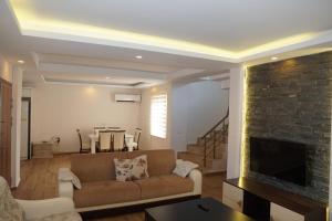 a living room with a couch and a fireplace at BlueHomes Villas in Belek