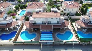 an aerial view of a house with blue swimming pools at BlueHomes Villas in Belek