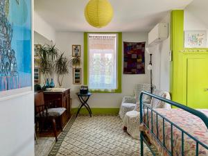 a bedroom with a bed and a desk and a window at Casa do Paço Aveiro Studio&Rooms in Aveiro