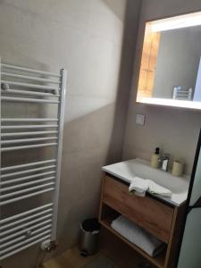 a bathroom with a sink and a mirror at Alex in Bjelašnica +4 photos