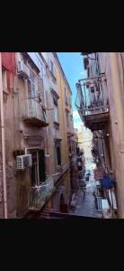 an alley with buildings and balconies in a city at Casa Concettina in Naples +8 photos