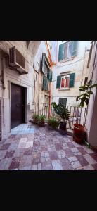 a building with a courtyard with plants in front of it at Casa Concettina in Naples