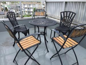 a group of chairs and a table on a balcony at TOKYOtomo in Wada