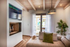 a living room with a couch and a fireplace at Ble Oneiro Villa Kira in Adamas