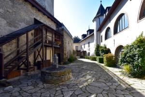 a courtyard of a building with a stone path at Chateau GrandCastle in Liptovský Hrádok