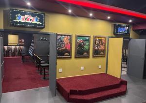 a room with a bunch of video games on a wall at Konayethu BnB in Mdantsane
