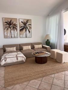 a living room with a couch and a coffee table at Villa Atenea by Aura Villas in Charco del Palo