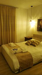 a bedroom with a large bed and a window at Daglas suit in Kannaviou