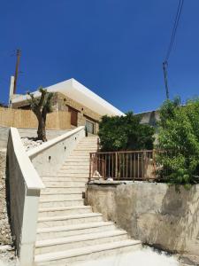 a set of stairs leading up to a house at Daglas suit in Kannaviou