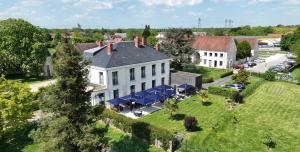 an aerial view of a large white house with a yard at Auberge du Chateau Bleu in Tremblay En France