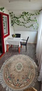 a room with a table and a bench and a rug at Cabana Dara in Cumpăna +46 photos
