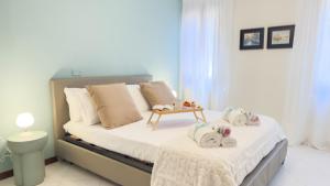 a bedroom with a bed with two dolls on it at Dimora Sotto le Stelle by Ca-Sa Check in Chioggia
