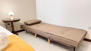 a bench in a bedroom with a lamp on a table at Dimora Sotto le Stelle by Ca-Sa Check in Chioggia