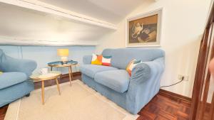 a living room with a blue couch and a table at Dimora Sotto le Stelle by Ca-Sa Check in Chioggia +32 photos