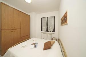 a bedroom with a bed and a cabinet at Il fiordaliso Blu in Desenzano del Garda +20 photos