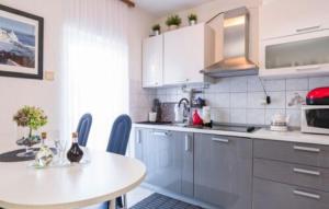 a kitchen with a table and a white counter top at Villa Tina Crikvenica by Villas Guide in Crikvenica