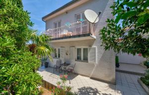 a house with a balcony with a table and chairs at Villa Tina Crikvenica by Villas Guide in Crikvenica