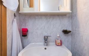a bathroom sink with a bottle of soap on it at Villa Tina Crikvenica by Villas Guide in Crikvenica +14 photos