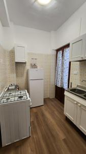 an empty kitchen with a stove and a counter top at La casetta di Totò in Palermo
