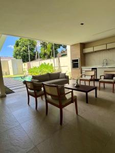a living room with a couch and a table at COP30 house in gated community in Ananindeua