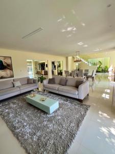 a living room with two couches and a table at COP30 house in gated community in Ananindeua