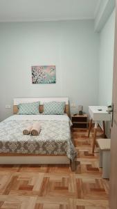 a bedroom with a bed and a wooden floor at Οδυσσέας & Σοφία in Igoumenitsa