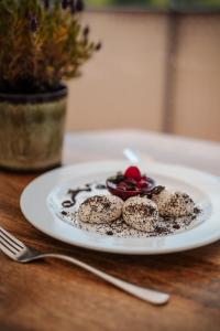 a white plate with some food on a table at Vivea Hotel Bad Traunstein 