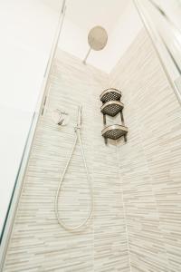 a shower with a shower head and a shower head at Happy Home Spazioso Trilocale Bologna a Due Passi Dal Centro in Bologna