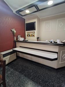 a hotel room with a table and a tv at Grand hotel in Ceres