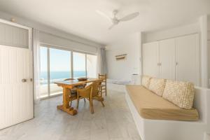 a room with a table and a bed and a desk at Eagles Nest Mykonos in Tourlos