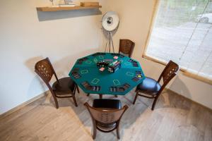 a room with a table with chairs and a fan at ARCADIA Village in Merei