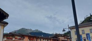 a town with buildings and a mountain in the background at Casa 33 in Predazzo