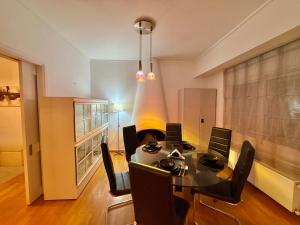 a dining room with a table and chairs at Central Glyfada 2BR Apartment in Athens