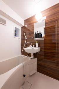 a bathroom with a sink and a bath tub and a toilet at Near Shibuya Station 4Beds 5Max A175 in Tokyo +14 photos