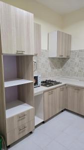 a kitchen with wooden cabinets and a stove top oven at Haven Height Executive Luxury Apartment in Lekki +9 photos