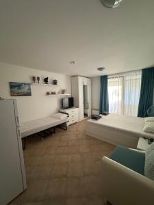 a large white room with a bed and a couch at Heritage in Oasis Resort Lozenets in Lozenets