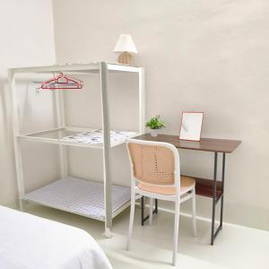 a desk and a chair next to a table and a bed at Simee Terrance Cozy Stay in Gua Sai +10 photos