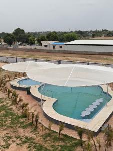 an overhead view of a large swimming pool with a canopy at HK Resort 