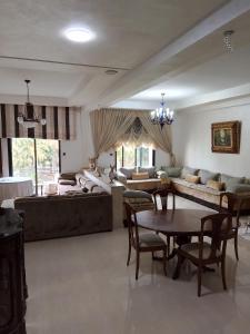 a living room with a couch and a table at B&B Séjour chez l'habitant in Rabat
