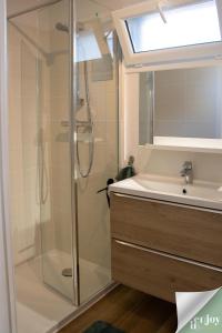 a bathroom with a shower and a sink at Logis Robin in Agon Coutainville
