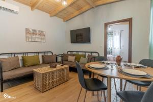 a living room with a couch and a table at Myrtali's Guesthouse Ιn Tzoumerka 